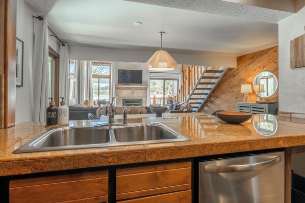 A modern kitchen with a granite countertop, stainless steel sink, and a dishwasher. - Mammoth Creek 36-Surround yourself by incredible mountain views! (Mammoth Lakes)