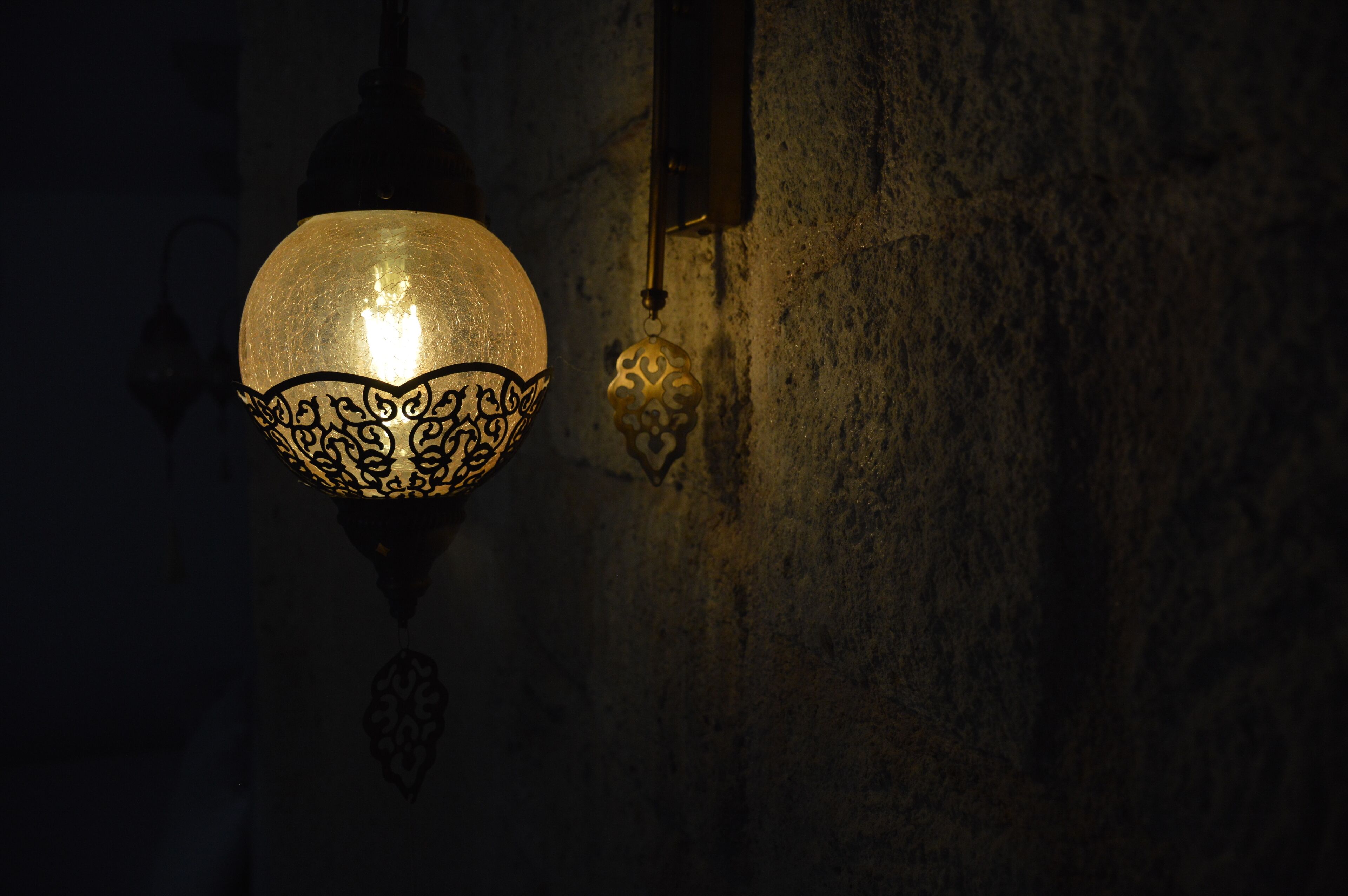 A wall-mounted lamp with intricate metalwork.