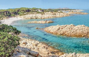 A coastal landscape with rocky shores, clear turquoise water, and a sandy beach. - 3 bedroom awesome apartment in Orosei (Orosei)