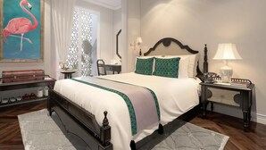 A bedroom with a large bed, a nightstand, a lamp, a painting of a flamingo, and a window with curtains. - Senses Central Hotel (Ho Chi Minh City)