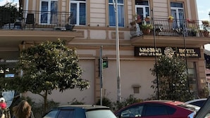 A multi-story hotel with a classic architectural style, featuring balconies with railings and potted plants. - Black Sea Star Batumi (Batumi)