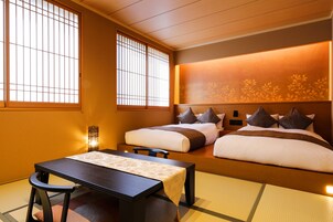 Deluxe Room east building | Down comforters, in-room safe, desk, iron/ironing board