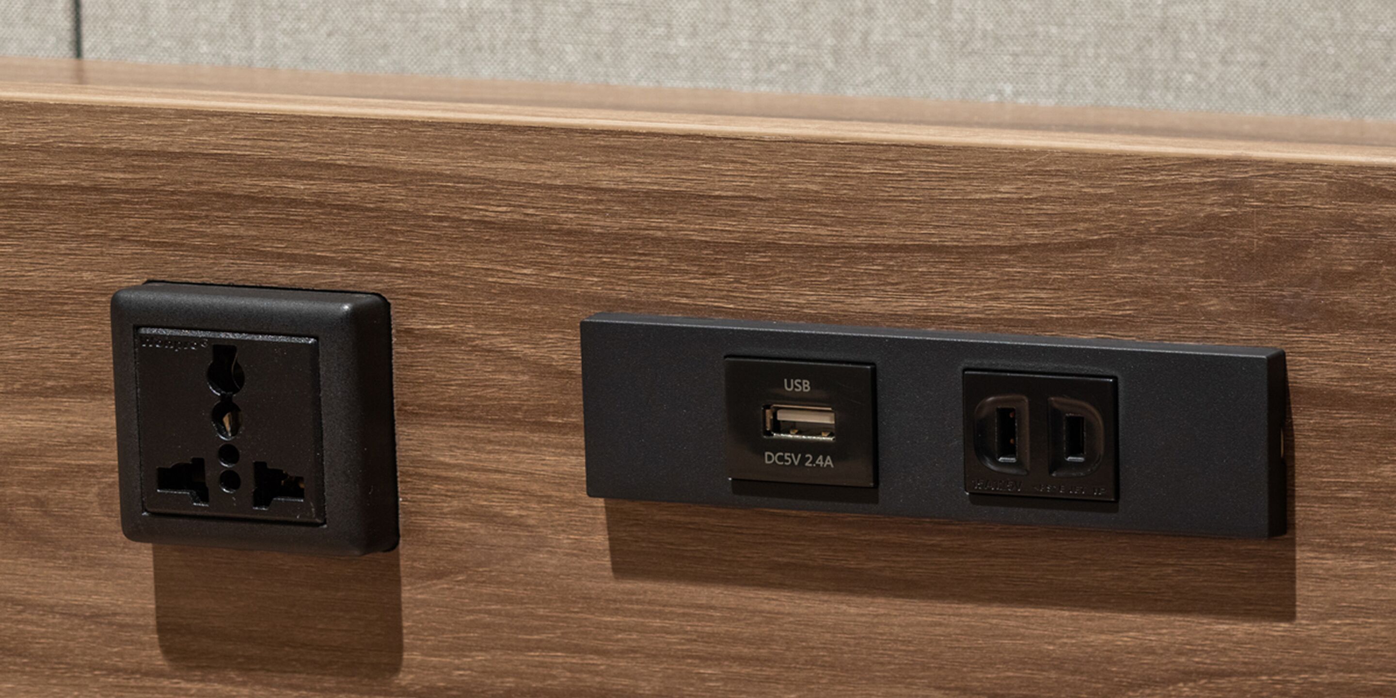 A wall-mounted electrical outlet with a USB port and a standard electrical outlet.