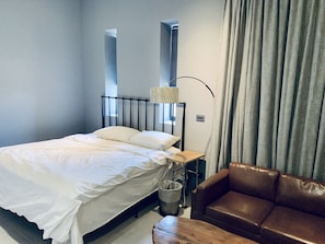 Premium bedding, desk, laptop workspace, blackout curtains