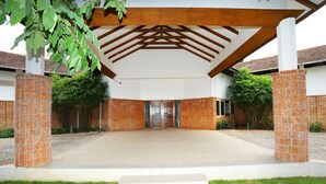 A covered entrance with a tiled floor, a central gate, and a pergola structure. - Capital O 29855 Island Inn (Kanayannur)