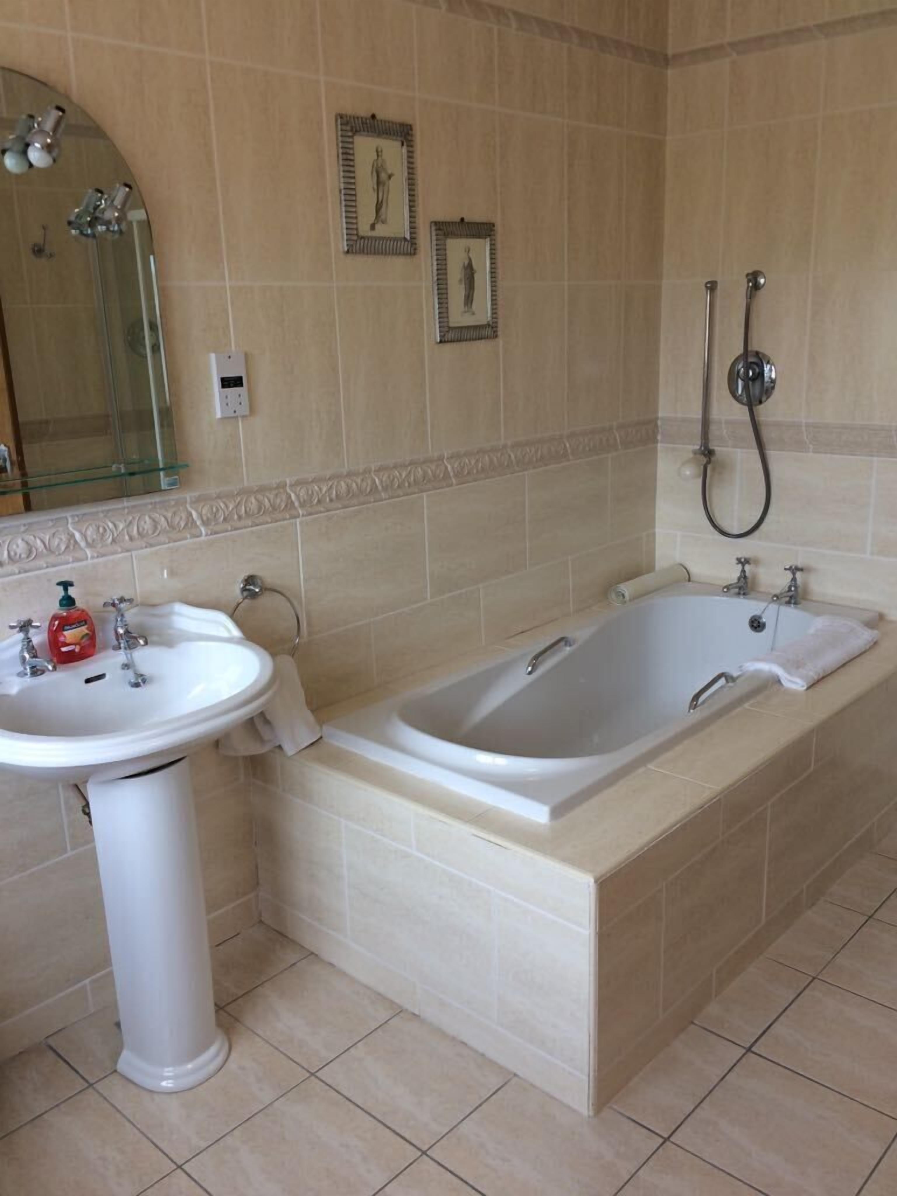 A bathroom with a sink, bathtub, and shower.