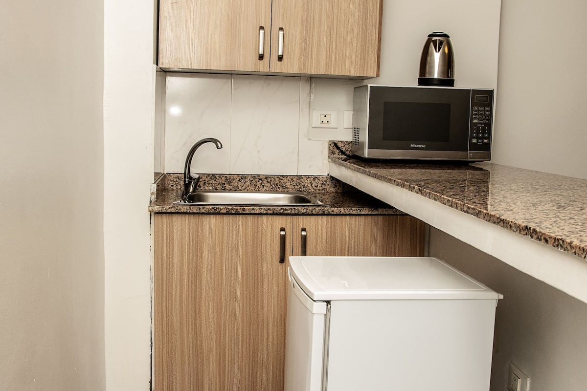 fridge, microwave, electric kettle, cookware/dishes/utensils