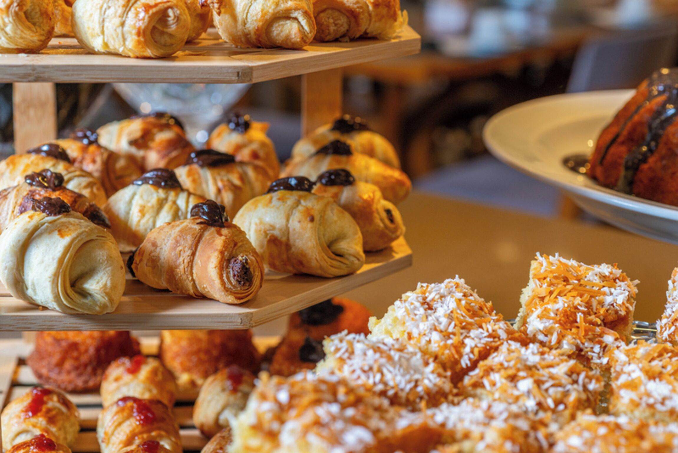 A display of various pastries on a wooden stand.