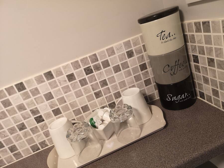 A coffee maker with a label that reads "Tea... Coffee... Sugar... nice and sweet."