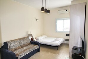 Classic Apartment | Living area | 32-inch flat-screen TV with cable channels, TV - Arendalzrail Apartments Rothschild St.33 (Bat Yam)