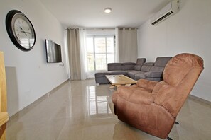 Family Apartment, 3 Bedrooms | Living area | Flat-screen TV