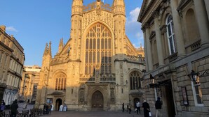 A historic building with intricate architecture, large arched windows, and a prominent central tower. - The King's Meadery (Bath)