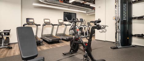 A gym with treadmills, a stationary bike, and weight machines.