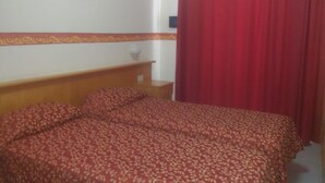 A bedroom with a bed, a nightstand, a framed picture on the wall, and a red curtain. - Sporting Baia Dependence Villa Athena (Giardini Naxos)