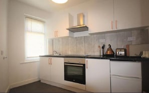 Enjoy cooking in this well-equipped kitchen with an oven and range hood.