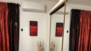 A bedroom with two beds, a large mirror, and a potted plant. - A second story house at less than 5 min walking from beach (Aguada)