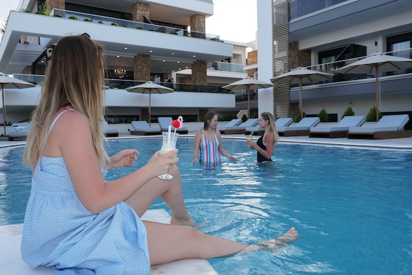 Seasonal outdoor pool, open 10:00 AM to 8:00 PM, pool umbrellas