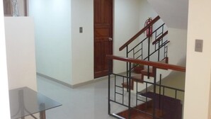A staircase with a wooden handrail and metal balusters, leading to an upper floor. - Mística Boutique Hotel (Arequipa)