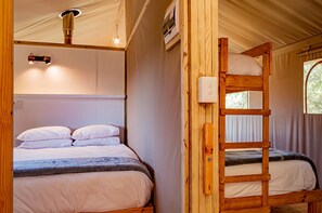 A bunk bed with a wooden ladder, a ceiling light fixture, and a window with curtains. - AfriCamps at Gowan Valley - Glamping (Balgowan)