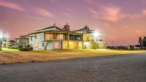 A modern two-story house with a spacious driveway and a well-maintained lawn. - The Anchorage (Vaal Marina)