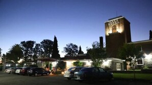 A hotel with a prominent tower labeled "HOTEL" at night. - EL MIRADOR HOTEL SPA (Colonia del Sacramento)