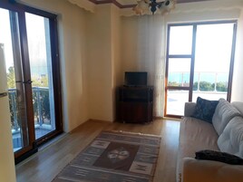 Standard Apartment, Sea View | Living area | 24-inch LCD TV with satellite channels