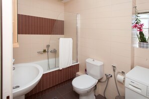 Bathtub, hair dryer, towels, soap