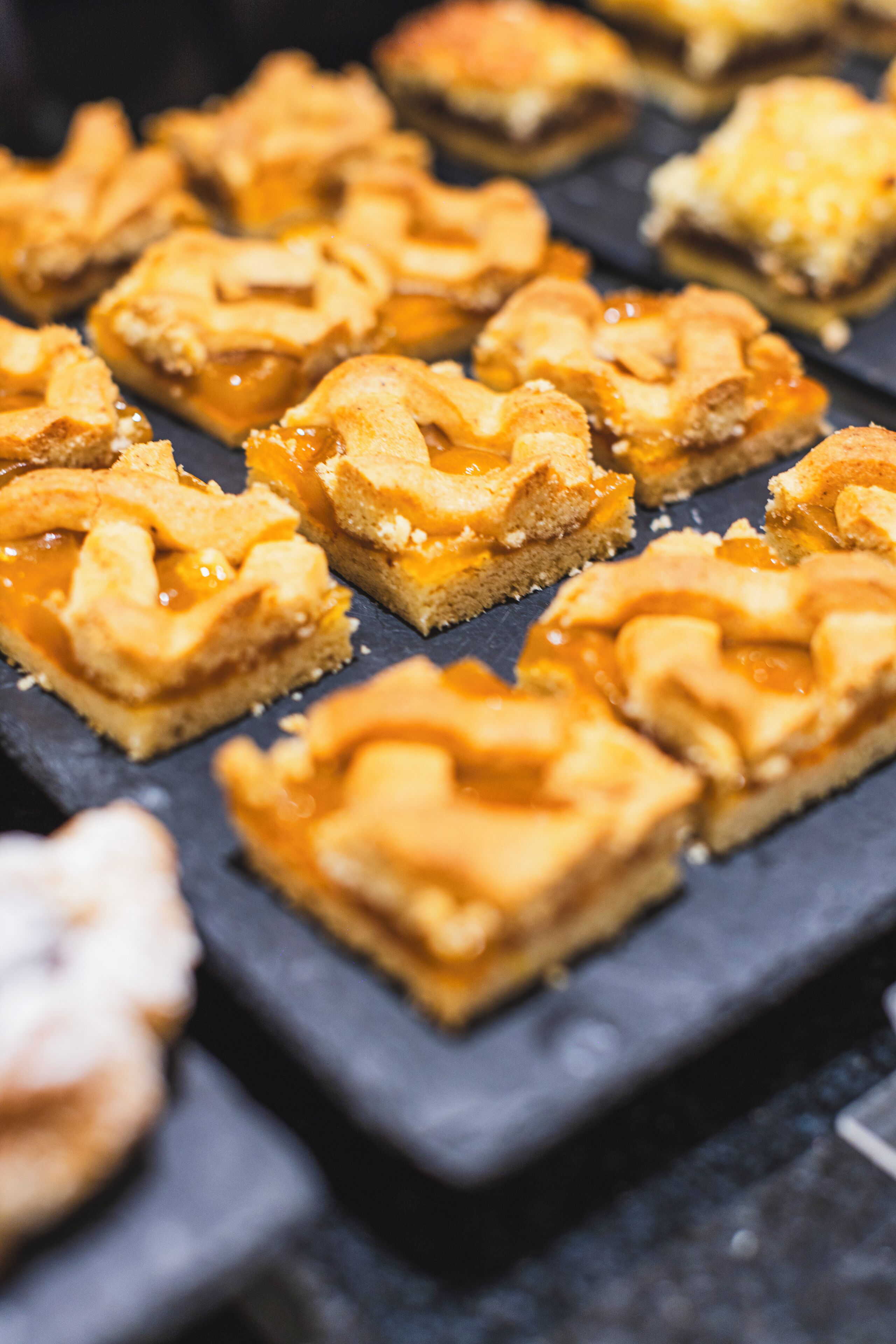 A tray of square pastries with a caramel topping.