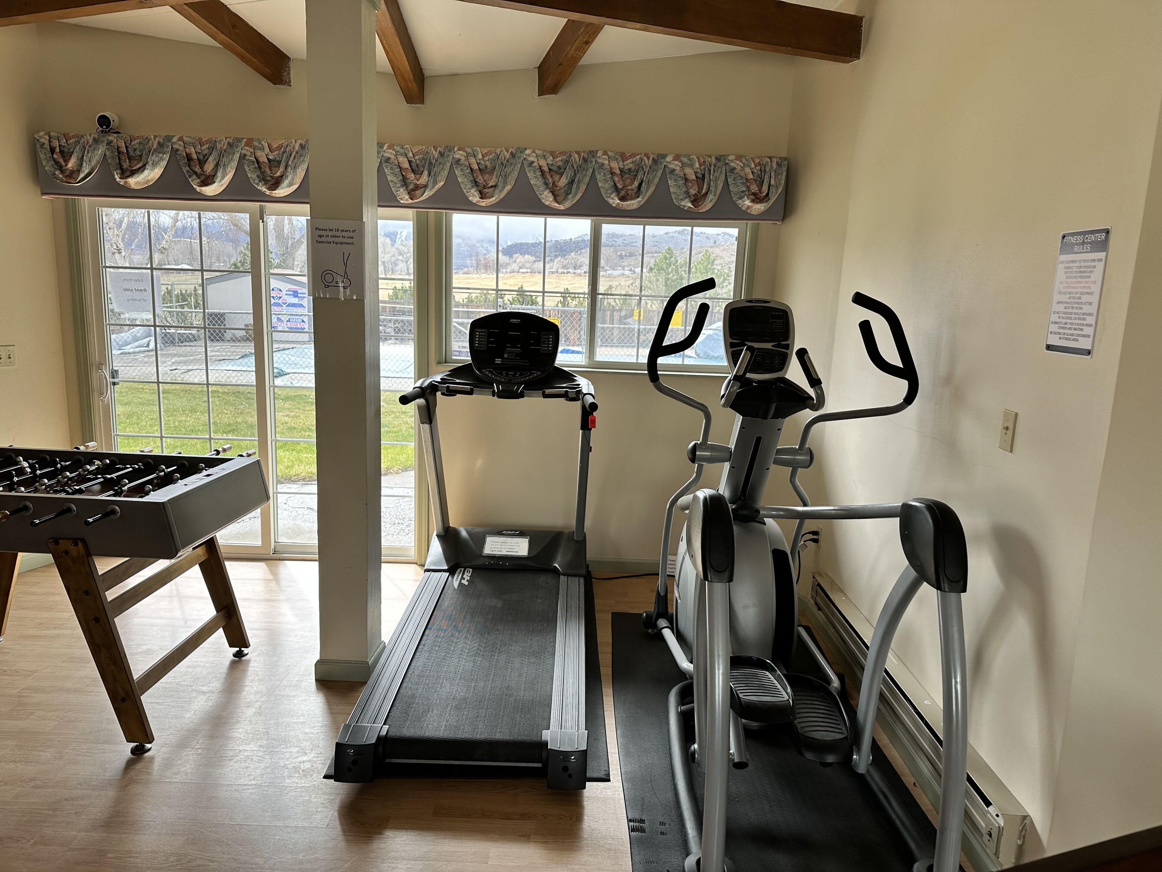 A gym with treadmills and a foosball table.