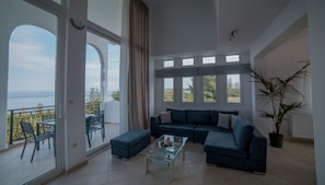 Relax in this stylish living area with a balcony offering breathtaking sea views.