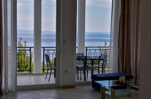 Enjoy the view from the balcony with a sofa and coffee table.