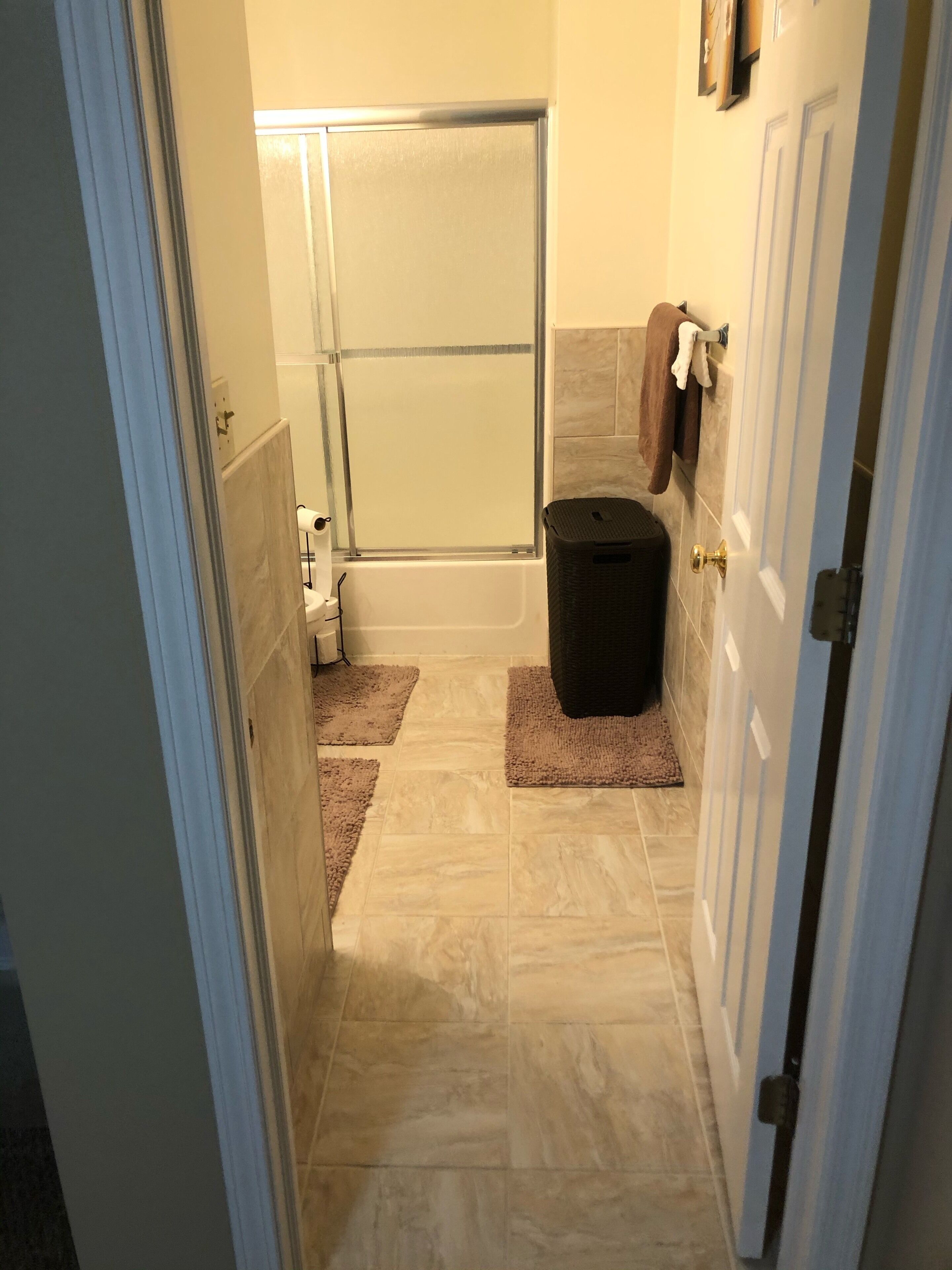 A bathroom with a shower, a toilet, and a sink.