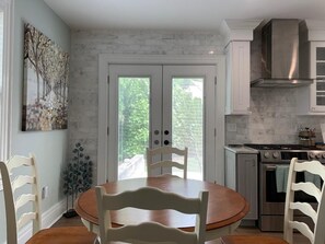 Enjoy meals in the kitchen with a central island and dining area, featuring a stove, oven, and cabinetry.