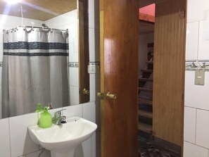 Bathtub, hair dryer, soap, toilet paper