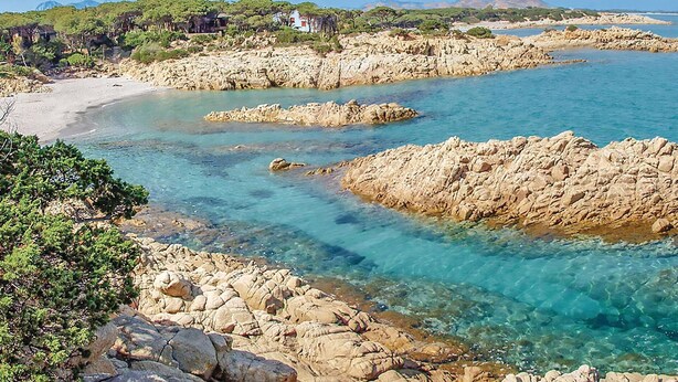 A coastal landscape with rocky terrain, clear turquoise waters, and a sandy beach. - Beach front apartment in Orosei (Orosei)