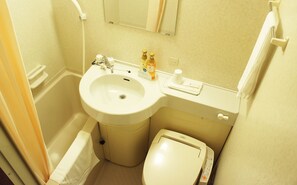 A bathroom with a sink, mirror, toilet, and hand soap.
