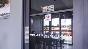 A guest house with a 'NO SMOKING' sign, free Wi-Fi, and a 'PUSH' button on the door.