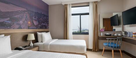 Deluxe Room, River View | Minibar, in-room safe, desk, laptop workspace