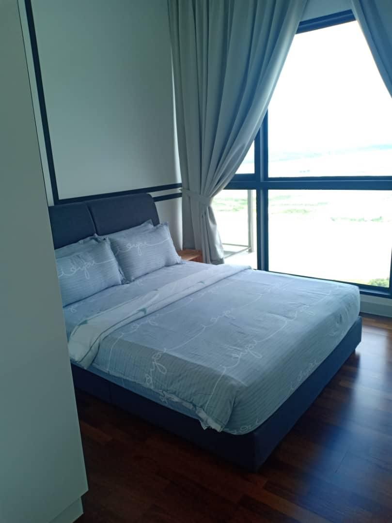 A bedroom with a bed, a window, and curtains.