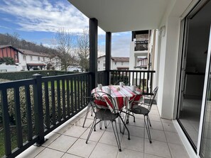 Enjoy meals on the balcony with a view of the surrounding neighborhood.