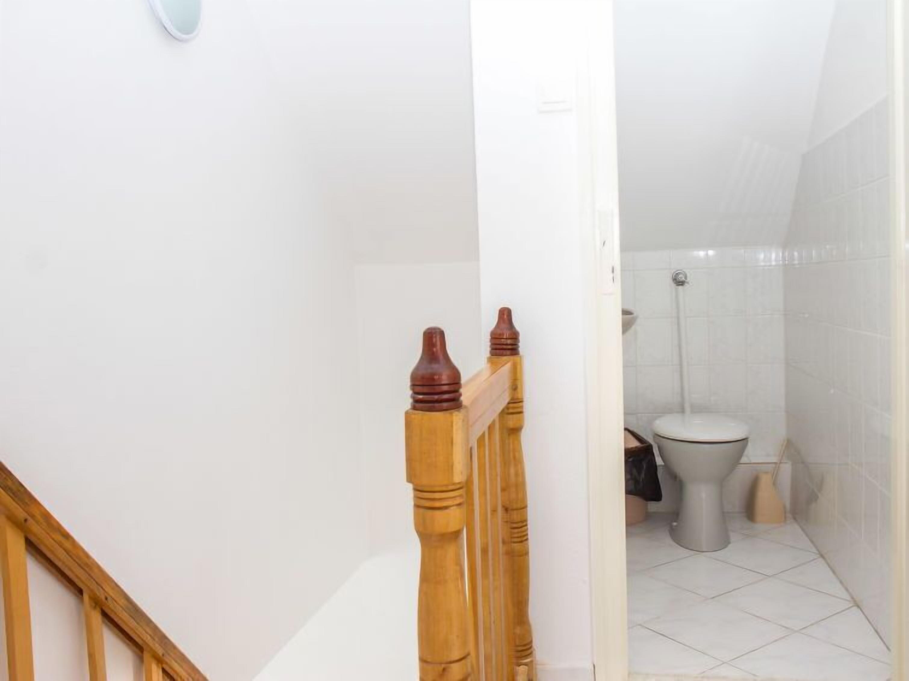 A bathroom with a toilet and a shower.