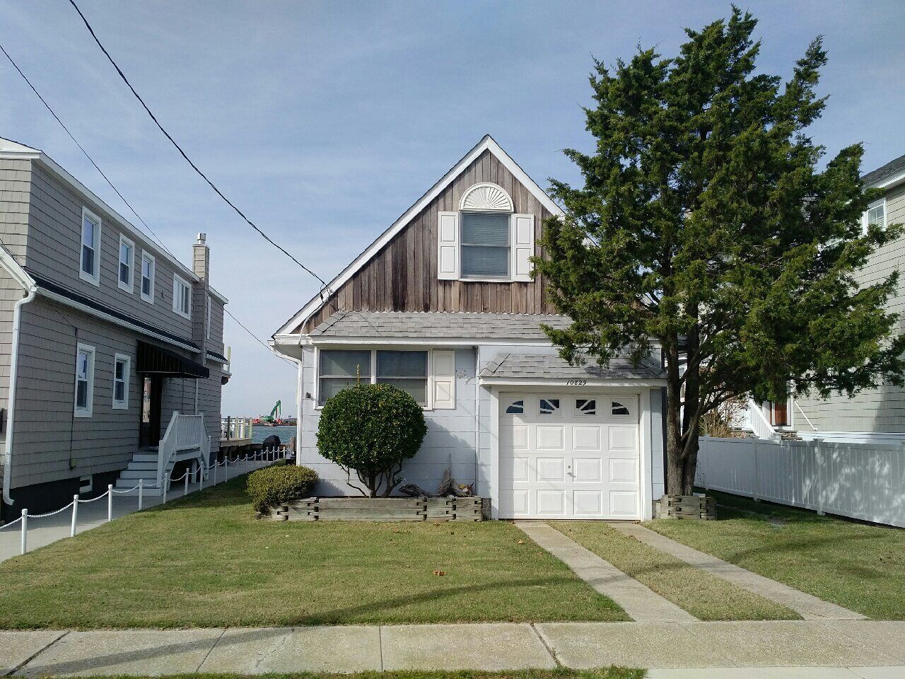 ADORABLE bay front cottage is tucked away on a quiet street with amazing SUNSET VIEWS