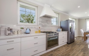 Fridge, stovetop, dishwasher, coffee/tea maker