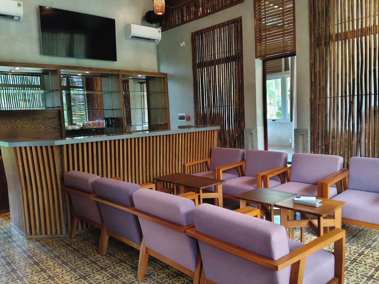 A reception area with a counter, seating, and a TV screen.