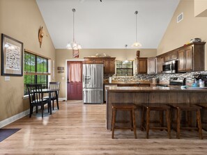 The equipped and well-stocked kitchen has plenty of seating.
