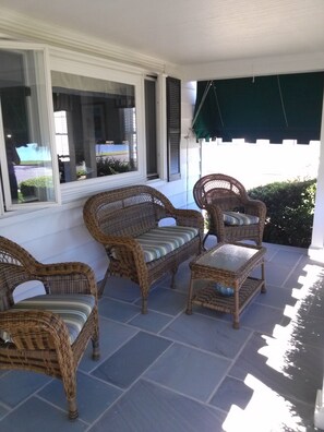 Relax on the front porch with views of the pond.