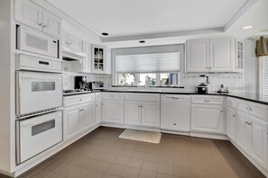 Enjoy cooking in this well-equipped kitchen with appliances and a coffee maker.