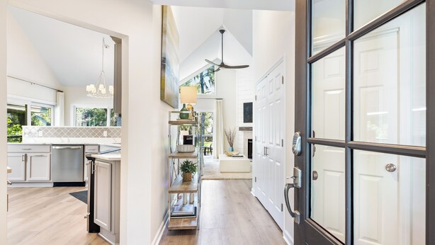 A spacious kitchen with modern appliances, a central island, and a view to the outdoors. - 21 Shell Ring:  BESTNEST by Beverly Serral Vacation Rentals (Hilton Head Island)