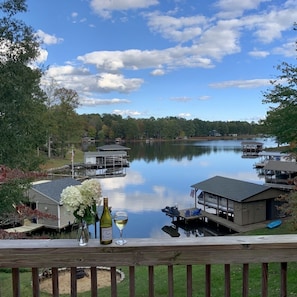 A lakeside property with docked boats, a gazebo, and a wooden deck overlooking the water. - Relaxing Lake Gaston Getaway (two separate living spaces; sleeps 9) (Henrico)