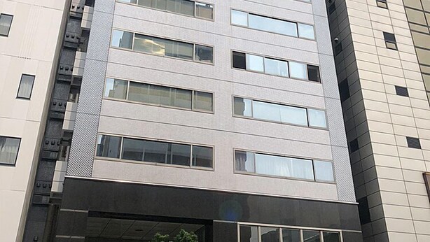 A multi-story building with a modern architectural design, featuring a mix of glass and concrete facades. - Residence Osaka Nipponbashi (Osaka)